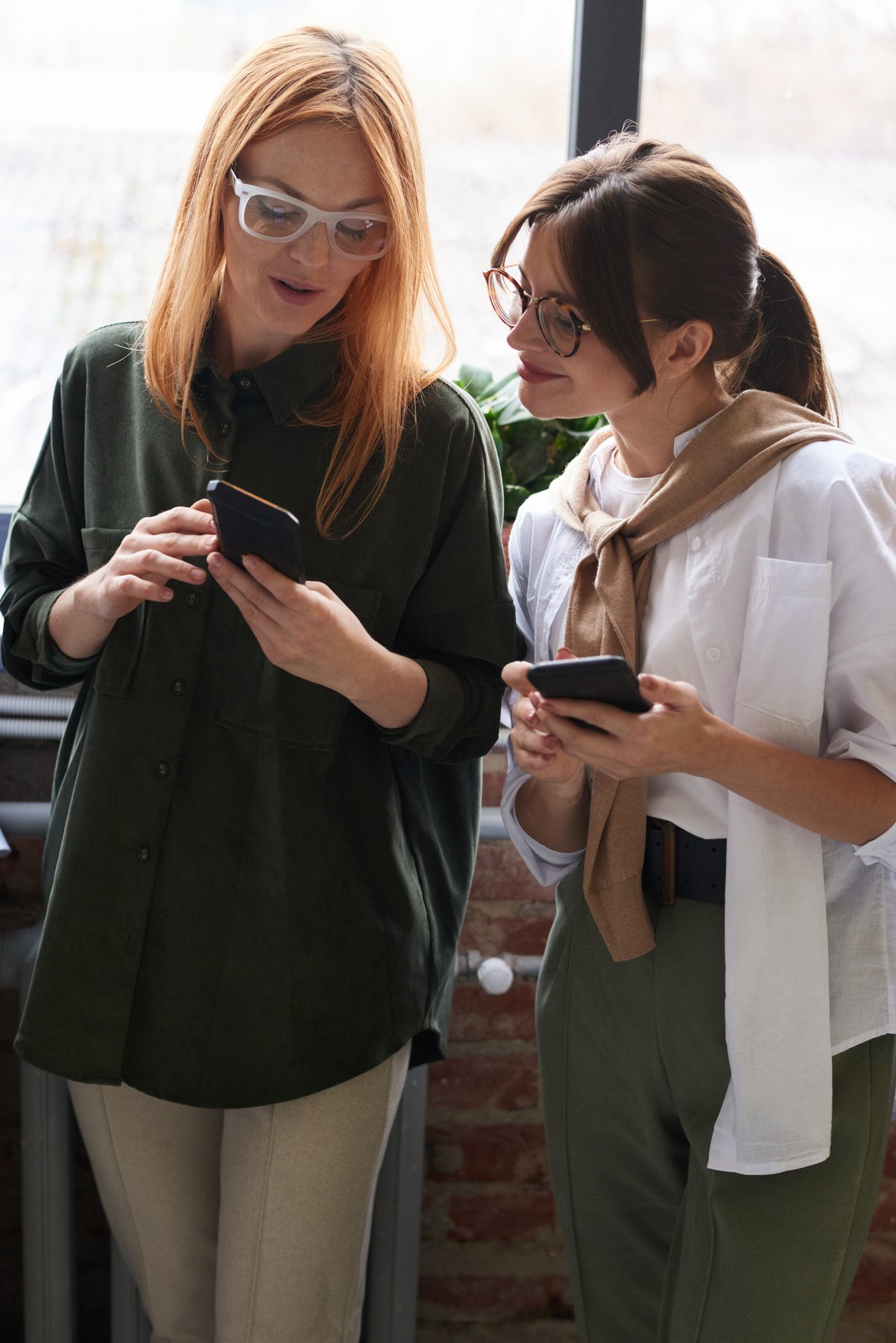 Photo Of Women Looking On Their Cellphones